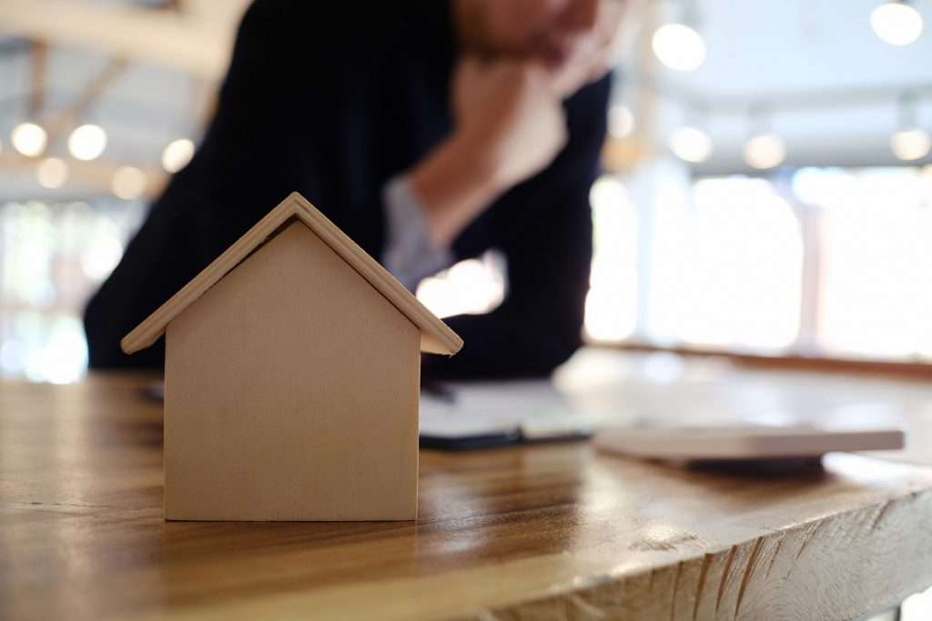 man thinking over house down payment