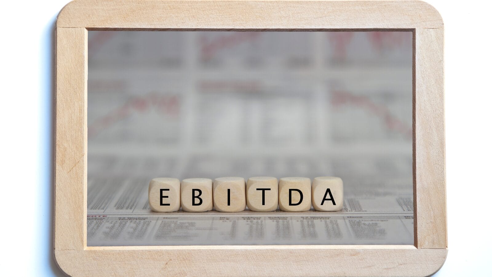 wooden blocks spelling EBITDA in a wooden frame