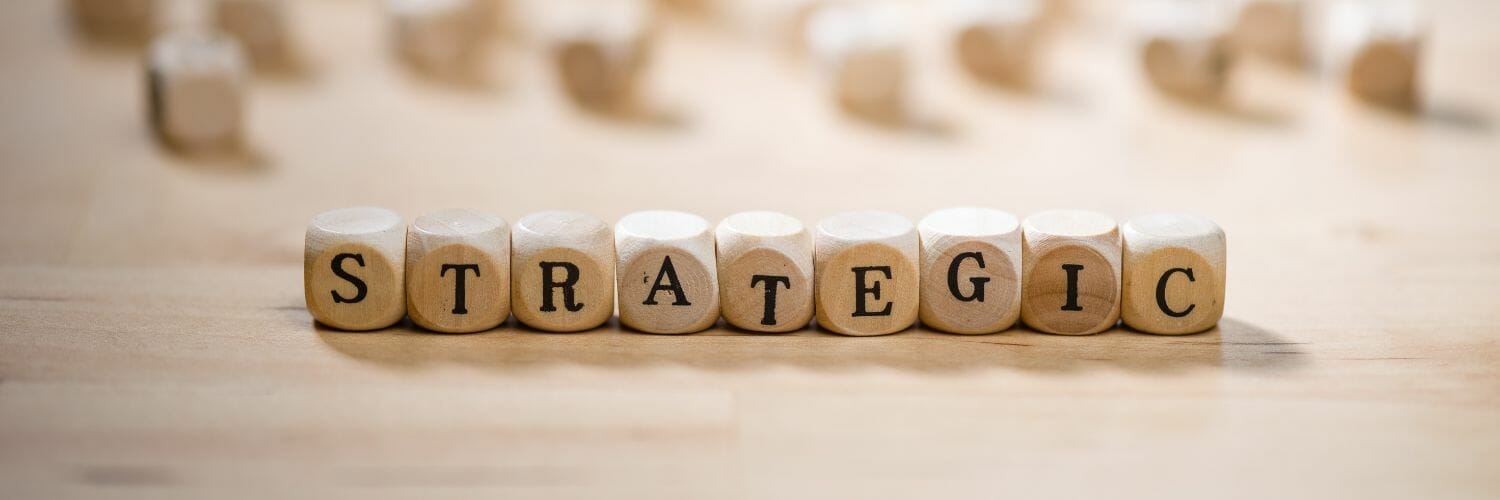 word strategic spelled out in wooden dice