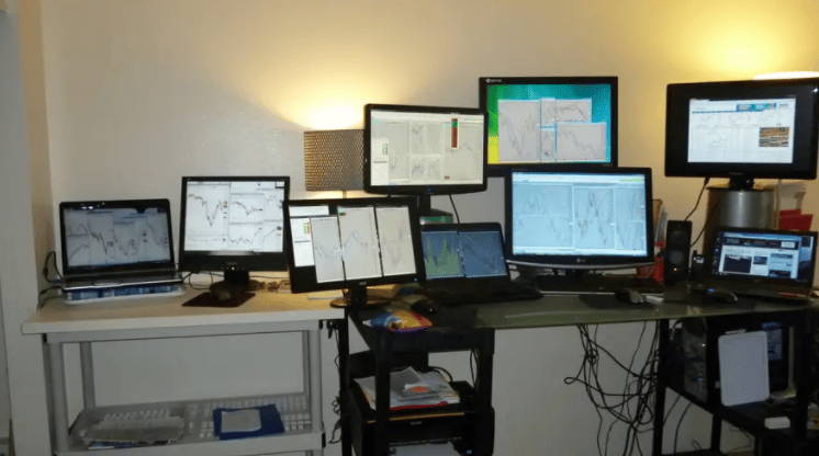 desk setup with many monitors