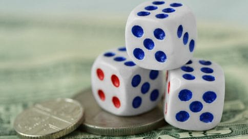 A stack of dice on a stack of coins