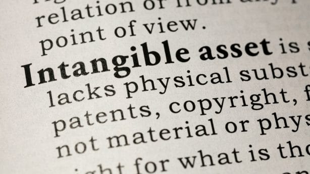 A close-up of a dictionary open to the definition of intangible assets

