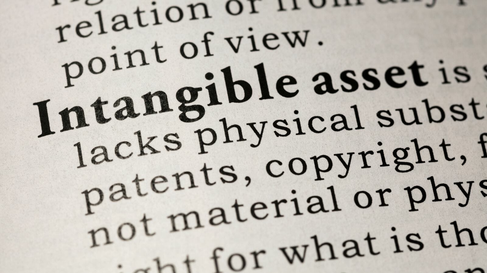 A close-up of a dictionary open to the definition of intangible assets