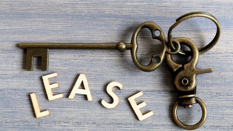 A picture containing key, metalware, wooden representing a lease

