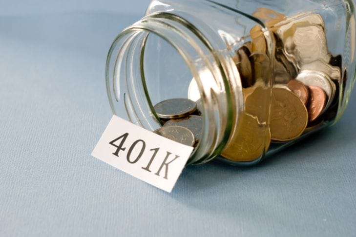 a jar of coins with a piece of paper saying 401k in front of it