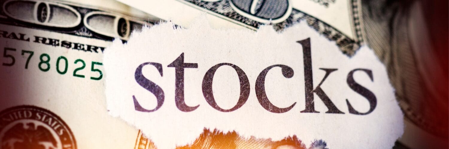 A close up of the word stocks over dollar bills