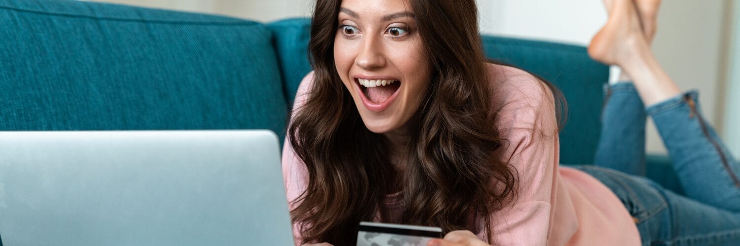 a woman excited at a computer screen
