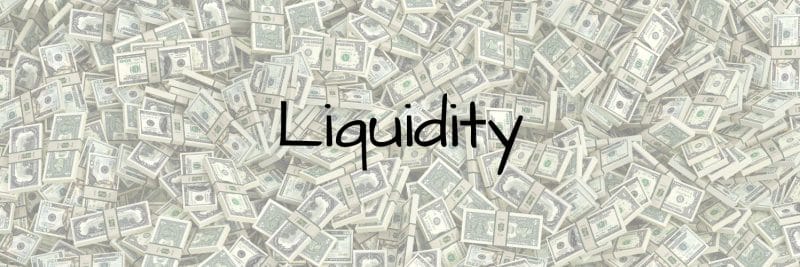Cash in the background with the word liquidity in the forefront