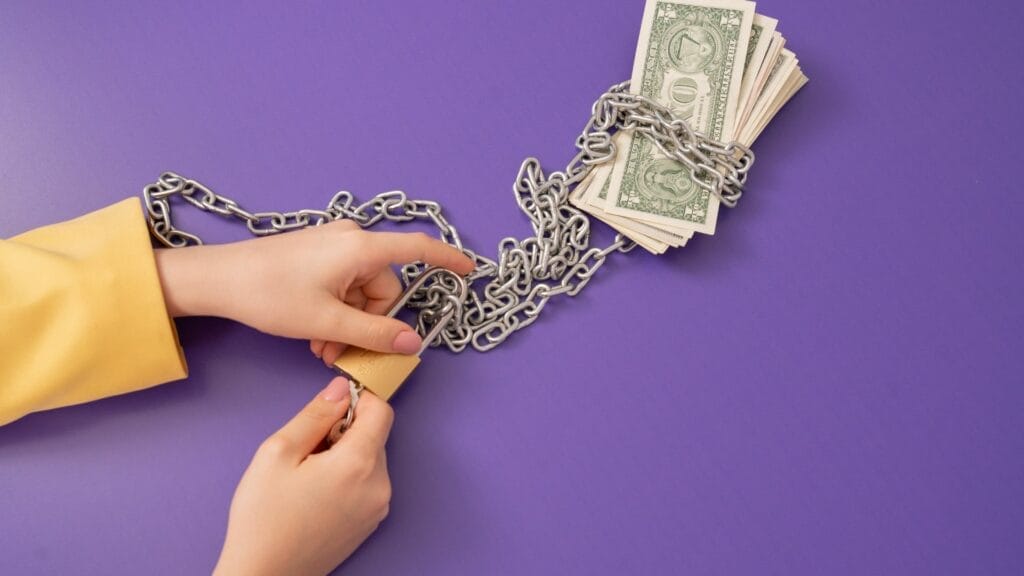 a person chained up to dollar bills