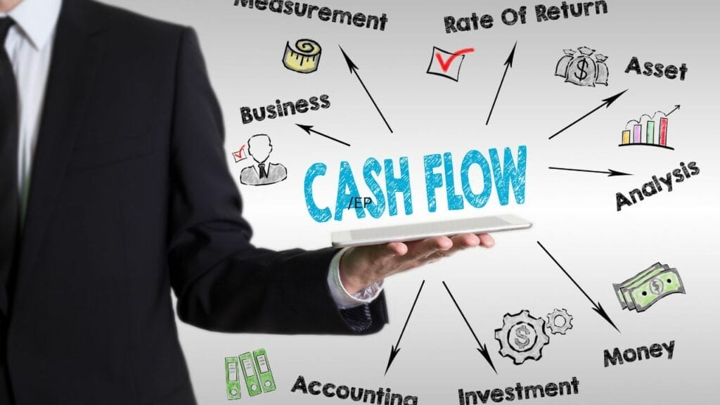 A person holding a tablet with cash flow above it and the factors that affect cash flow