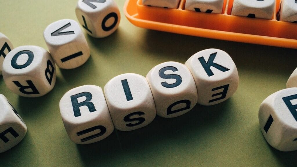 wooden letter blocks spelling "risk"