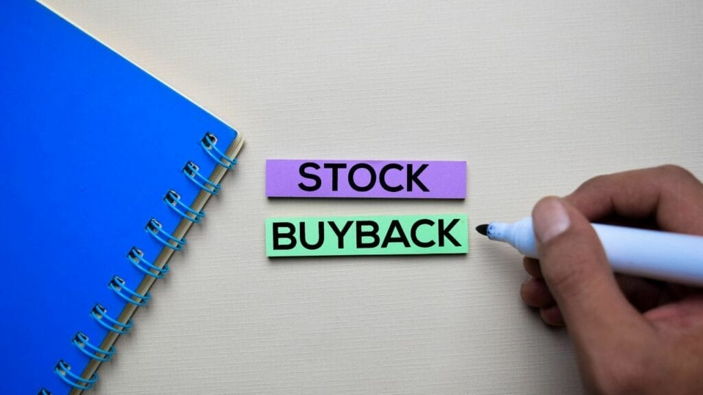 a person writing "stock buyback" on sticky notes