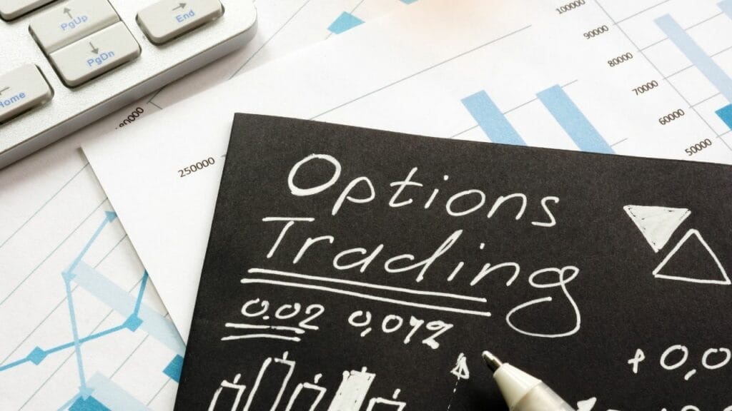 a piece of paper with options trading written on it next to a keyboard