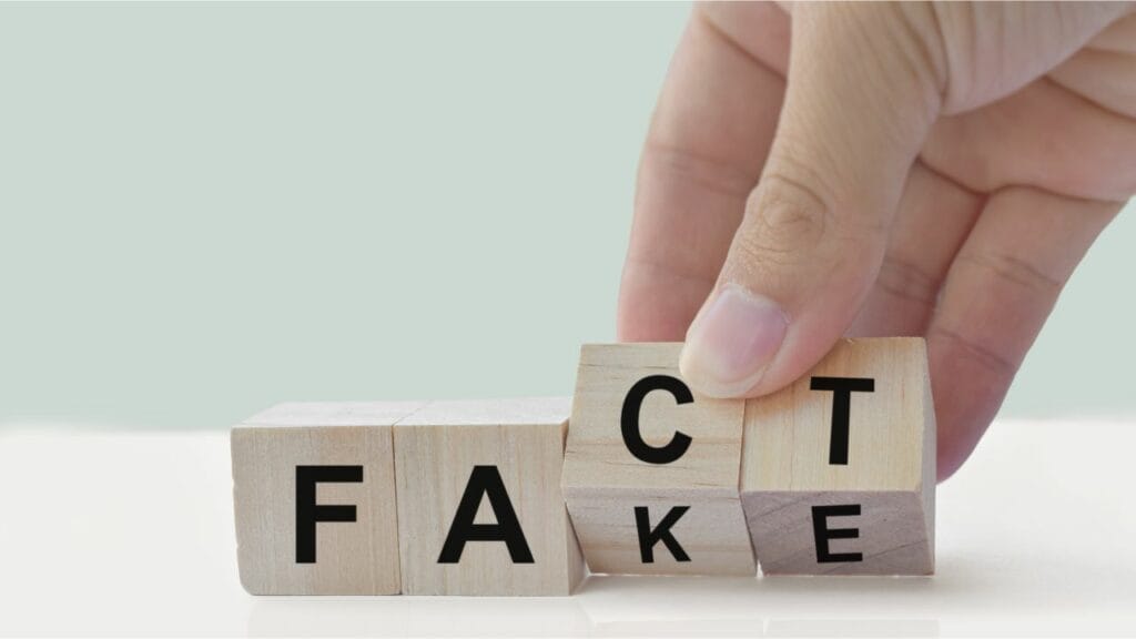 a person spinning wood blocks to spell "FACT"